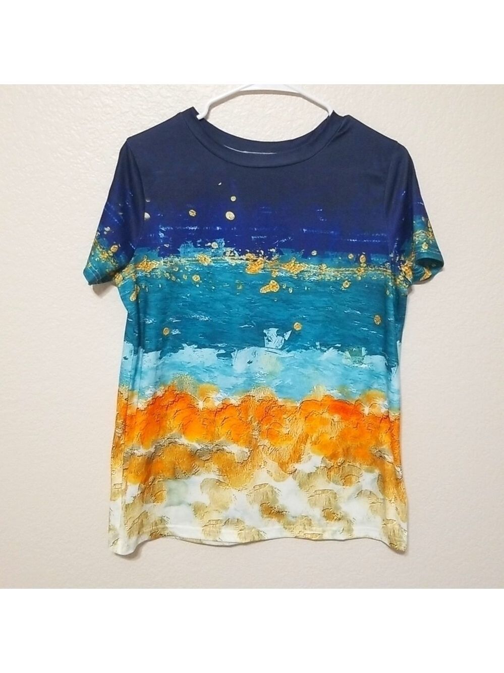 Nice top ,tee shirt, short sleeves, colorful, size Medium.